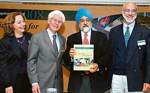 Planning Commission deputy chairman Montek Singh Ahluwalia unveils the World Development Report 2008 in the presence of World Bank country director in India Isabel Guerrero (L), principal co-author of the report Alain de Janvry and director in Asia, IFPRI, Ashok Gulati (R), in New Delhi on Friday.