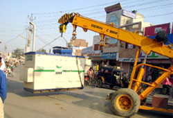 A crane acquired by MC removes a high-power generator that had been a source of trouble for the shopkeepers near the Shaheed Bhagat Singh chowk in Abohar