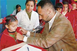 Children being examined during medical check-up camp in Ashma International School, in Mohali on Friday