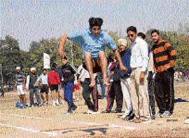 A PU student participates in the long jump event during the university sports festival in Chandigarh on Friday. 