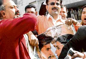Activists of the Bajrang Dal and Rajput Maha Sabha tear posters of film ‘Jodhaa Akbar’ outside Nirman Theatre in Sector 32, Chandigarh