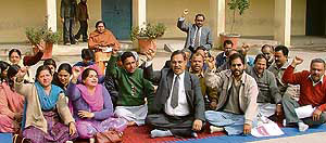 Teaching and non-teaching employees of Arya College stage a dharna in Ludhiana on Saturday.
