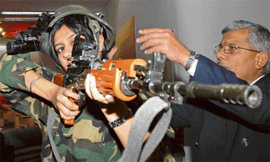 A model dressed up as a soldier takes aim with a Multi-Purpose Aiming Reflex Sight (MARS) rifle during the inauguration of DefExpo 2008 at Pragati Maidan in New Delhi on Saturday.