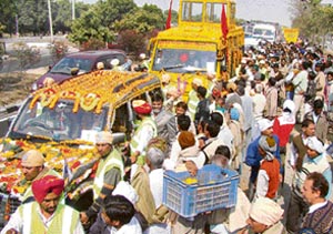 Devotees take part in a shobha yatra on the eve of the 631st birth anniversary of Guru Ravidas in Karnal on Sunday. 