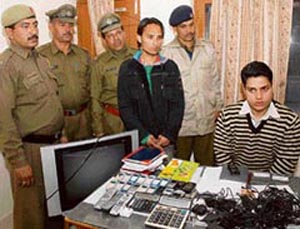 Vikas (centre), who was arrested by the police for his alleged involvement in a cricket betting racket in Karnal on Sunday. Nineteen mobile phones and registers were seized from him.