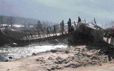 inviting tragedy: Tragedy awaits this foot bridge across the Beas at Seo Bagh, near Kullu, hanging precariously for the past one month. As hundreds of local residents use this bridge, it may endanger lives one day if not repaired in time.