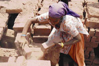 A labourer works at a brick-kiln on the outskirts of Jammu.