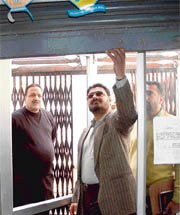 Police officials inspect the shutter of the State Bank of India, Sector 30, on Monday.