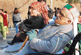 An old couple enjoys sunny weather in Shimla on Monday.