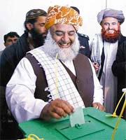 Jamiat Ulma-e-Islam leader Maulana Fazal-ur-Rehman casts his vote at a polling station in Dera Ismael Khan