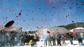 Flower petals are thrown in the air during the opening ceremony of the National Winter Games at Gulmarg, 55 km from Srinagar, on Monday