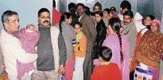 Patients and attendants stand in congested corridors of the paediatric and gynae OPDs.