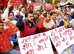 Workers of the National Conference protest over hike in fuel prices outside Governors house in Jammu on Tuesday. 
