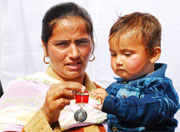 Manjeet Kaur, widow of Sapper Harpal Singh, showing the award given in recognition of her husbands sacrifice.
