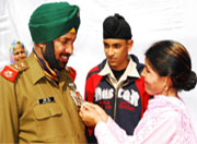 Subedar Nirmal Singh flanked by his son and wife after he being awarded the Sena Medal.