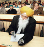 Dr S.S. Swatch take notes during a seminar at PAU