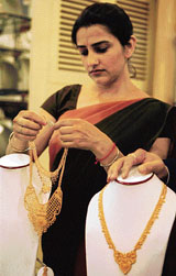 A sales woman arranges jewellery at a jewellery shop in New Delhi on Thursday.