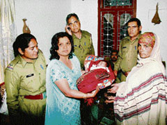Alka Jakhar hands over the newborn girl, which she had found abandoned, to a woman claiming to be the childs grandmother in Rohtak on Thursday.