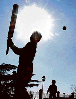  Children play cricket in a street in Shimla on Thursday. 