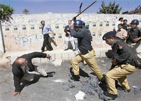 Policemen beat up a lawyer during a rally in Karachi