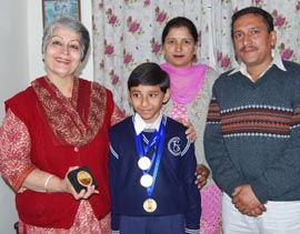 Archit Gupta with his parents and principal of Senior Study School Kanchan Mehra (extreme Left) in Amritsar. 