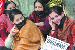 Teachers under the banner of DUTA sit on a dharna in front of St. Stephen's College against the acting principal and OSD of the college on the Issue of show cause notices to two senior women colleagues of Delhi University in the Capital