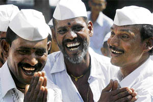 Dabbawallas attend a laughter therapy session to beat stress in Mumbai on Friday. More than 200,000 tiffin boxes are delivered by a team of nearly 5,000 carriers daily across Mumbai.