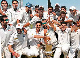 North Zone players pose with the Duleep Trophy after beating West Zone in the final at the Wankhede Stadium in Mumbai on Friday.