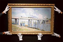 Christie's employees hold a painting entitled 'Le Pont du chemin de fer  Argenteuil' by French artist Claude Monet at Christie's auction house in London on Friday. The painting is estimated to fetch  175 million ($350 million) when it is auctioned in New York on May 6, 2008.