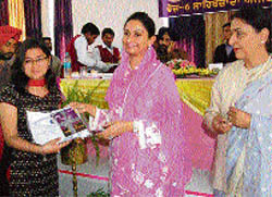 Harsimrat Badal, wife of Sukhbir Badal, gives away a prize to a student in Mohali 