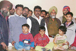 Autorickshaw drivers are all smiles while posing for a picture with the three rescued children.