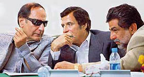 Chaudhry Shujjat Hussain (L), chief of pro-Musharraf Pakistan Muslim League-Q (PML-Q) chats with Chaudhry Pervaiz Elahi (C) during a party meeting in Islamabad on Saturday.