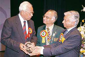 Tribune trustee N.N. Vohra (left), currently serving as government of India's interlocutor with J & K, receives the Rotary Shreyas award from T.K.A. Nair, principal secretary to Prime Minister, as Shaju Peter, governor of the host district 3080, looks on, at Indradhanush Auditorium in Sector 5, Panchkula, on Sunday.