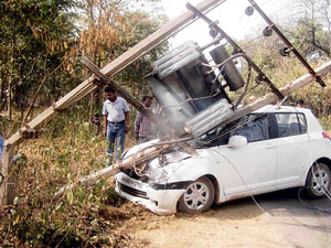 The occupants of this car had a narrow escape when poles holding a transformer fell on it on Old Saharanpur Road in Yamunanagar on Sunday.