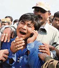 A relative of a victim of the bus accident cries at the accident site near Guwahati