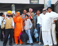 Commuters wait for buses at the Bathinda bus stand on Monday.