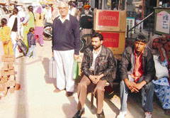 People wait for buses at Raikot in Ahmedgarh on Monday. 