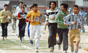 Students of Arya College take part in 5000m race during 61st Annual Athletics Meet in Ludhiana on Monday. 