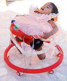 Lakshmi Tatma, 2, uses a baby walker to take steps at her home in a village on the outskirts of Jodhpur