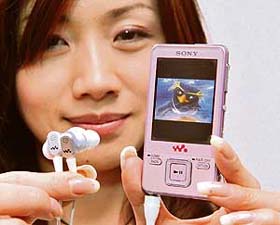 A Sony employee displays a new card-sized multimedia player "Walkman NW-A829", equipped with a 16 GB built-in flash memory that can store digital music, pictures and movie contents, and also has a built-in digital broadcasting tuner to show TV programmes on a 2.4-inch LCD display, in Tokyo