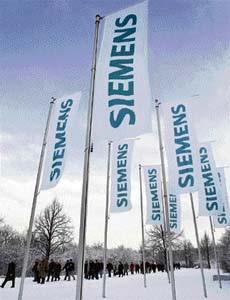 In this file photo, shareholders of Germany's Siemens AG arrive for the company's annual general meeting in Munich