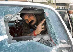 Devinder Katoch shows the smashed windowpane of his car outside his Sector 46 residence, Chandigarh, on Tuesday.