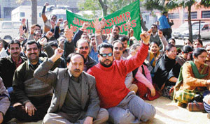 Members of the Jammu-Kashmir Health Department Association protest in support of their demands in Jammu on Tuesday. 
