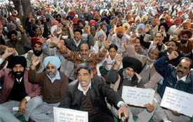 Protesting employees of the Punjab Water Resources Management and Development Corporation raise slogans at the head office of the corporation in Sector 26, Chandigarh, on Tuesday.