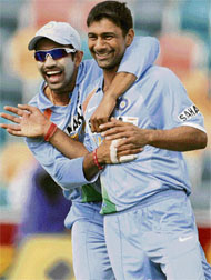 Praveen Kumar and teammate Robin Uthappa celebrate the fall of Kumara Sangakkaras wicket.