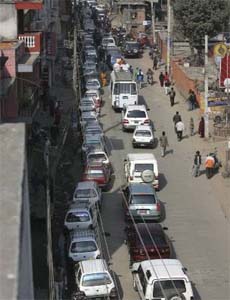 Vehicles wait for their turn to refill at a petrol station in Kathmandu