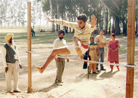 A participant performs high jump during the 37th annual athletics meet of Government College, Karamsar in Mandi Ahmedgarh on Wednesday.