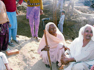 Ninety-year-old Atami Devi of Iserpur village leads women to stop construction work on the boundary wall of Deenbandhu Chhotu Ram Thermal Plant in Yamunanagar on Thursday. 