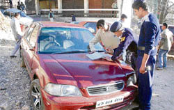 A traffic violator being challaned near Sabji Mandi during a drive to promote safe driving in Shimla