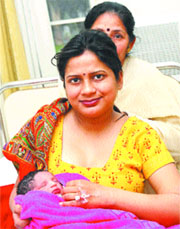 Ruchi Chaudhary holds her leap-year baby at a hospital in Jalandhar on Friday.